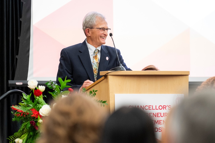 James Dahlberg speaks at podium during the awards ceremony