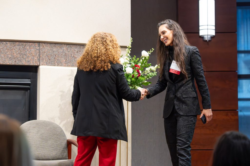 Chancellor Jennifer Mnookin shakes hands with Heather Hasson