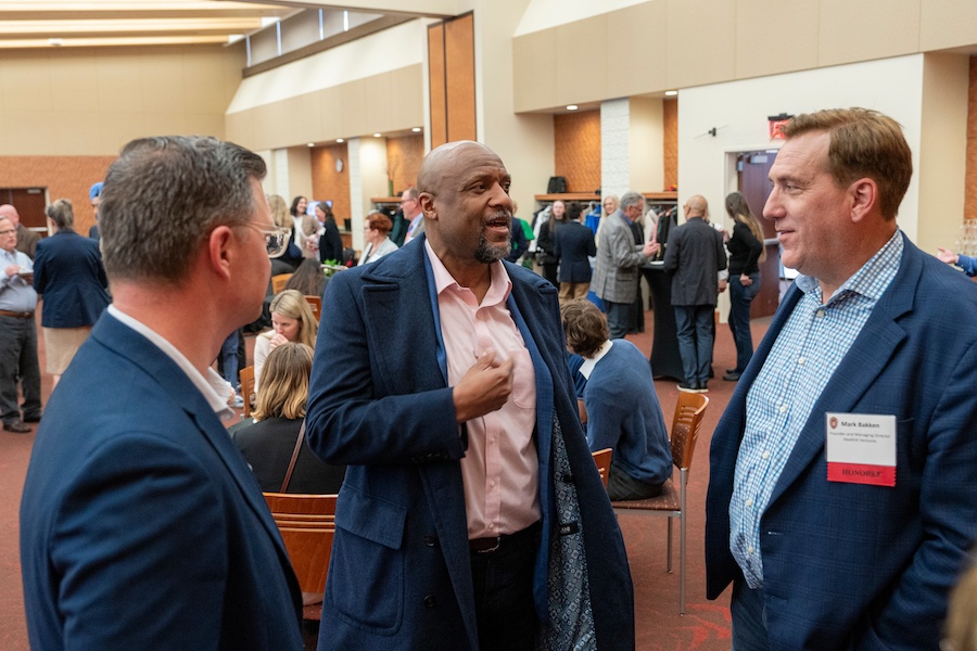 Award recipient Mark Bakken chats with two other guests at the awards reception