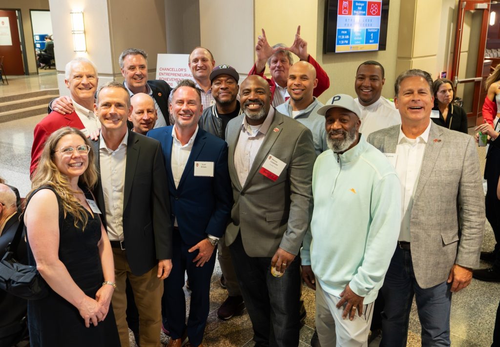 Marcus Carpenter with a group of smiling guests at the 2025 Chancellor's Awards ceremony